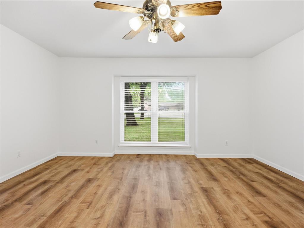209 Valley View Court Azle, TX 76020 - Photo 27 of 39 Unfurnished room with ceiling fan and light wood-type flooring