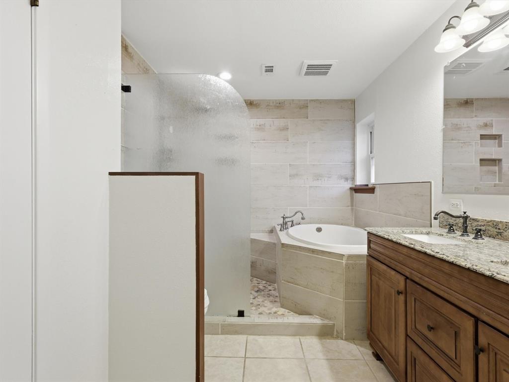 209 Valley View Court Azle, TX 76020 - Photo 29 of 39 Full bath with vanity, a garden tub, a shower stall, and light tile patterned flooring