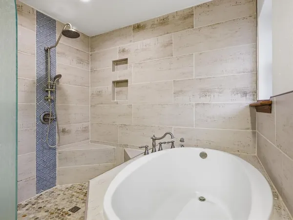 a bathroom with a bathtub and a shower