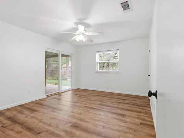 wooden floor in an empty room with a window