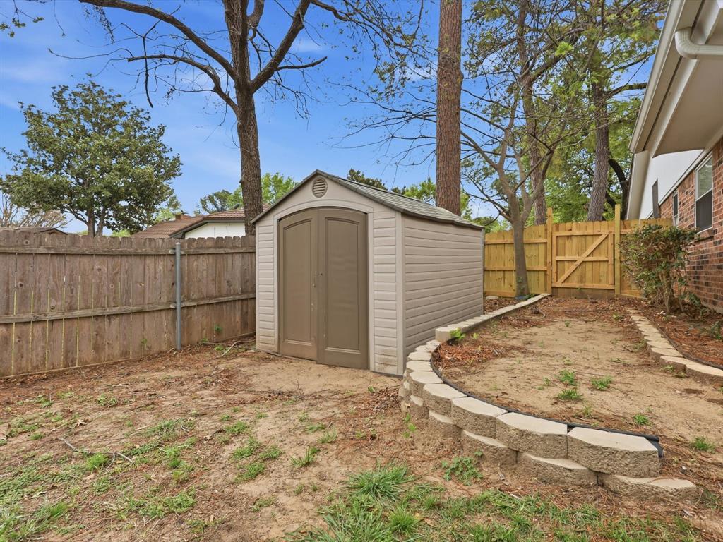209 Valley View Court Azle, TX 76020 - Photo 37 of 39 View of shed with a gate and a fenced backyard