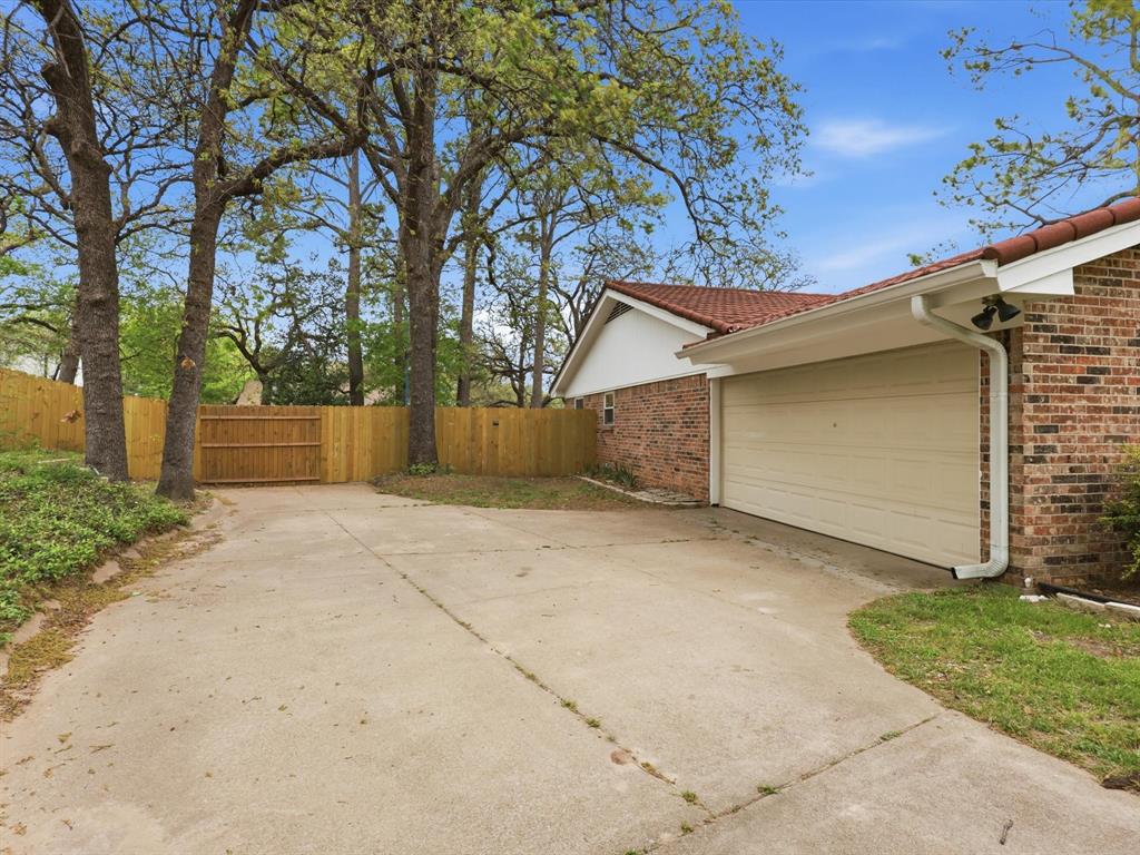 209 Valley View Court Azle, TX 76020 - Photo 4 of 39 View of home's exterior featuring brick siding, driveway, and a garage