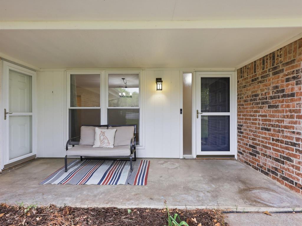 209 Valley View Court Azle, TX 76020 - Photo 5 of 39 Doorway to property with a patio area and brick siding