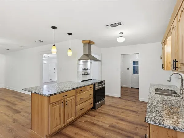a bathroom with granite countertop a sink and a mirror
