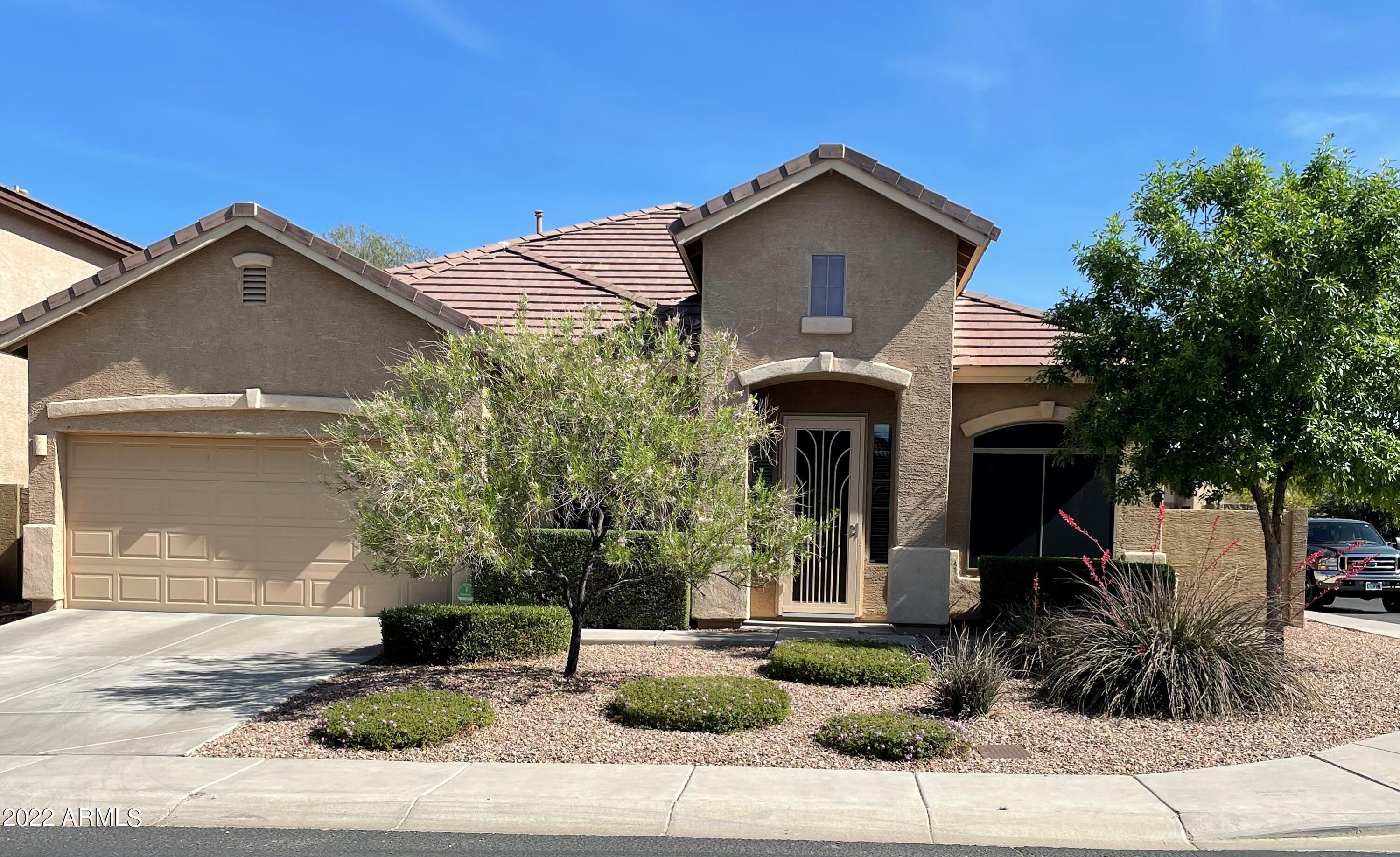 4604 West Moss Springs Road Phoenix, AZ 85086 - Photo 1 of 15 a front view of a house with garden