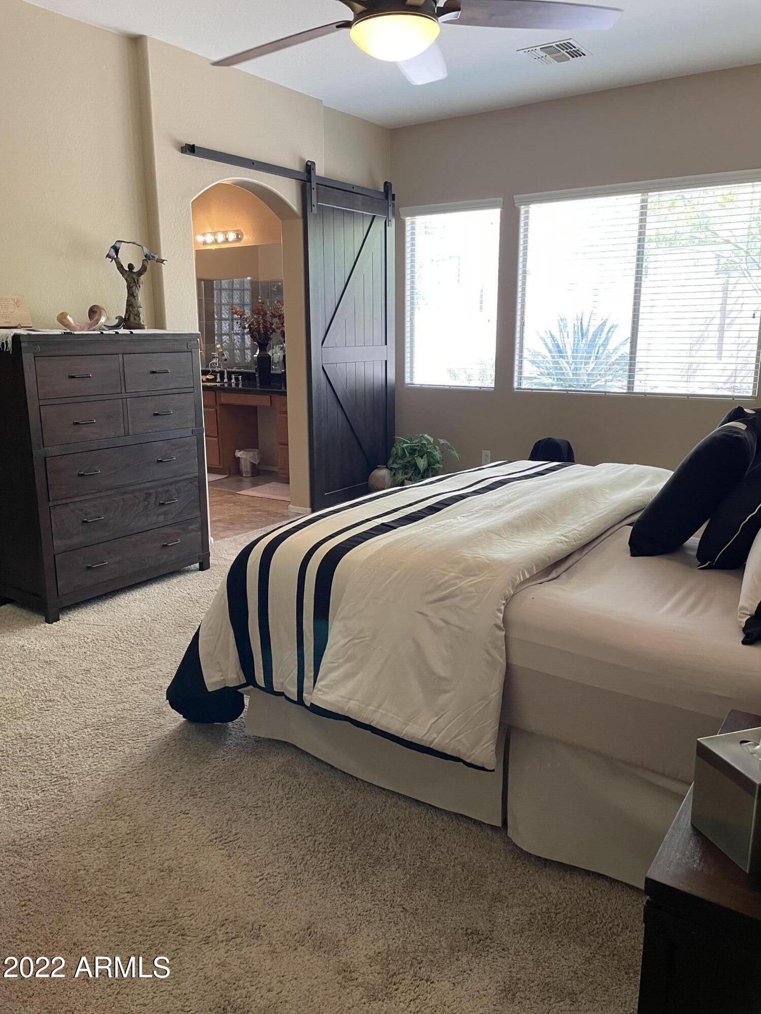 4604 West Moss Springs Road Phoenix, AZ 85086 - Photo 14 of 15 a bedroom with a bed and a dresser