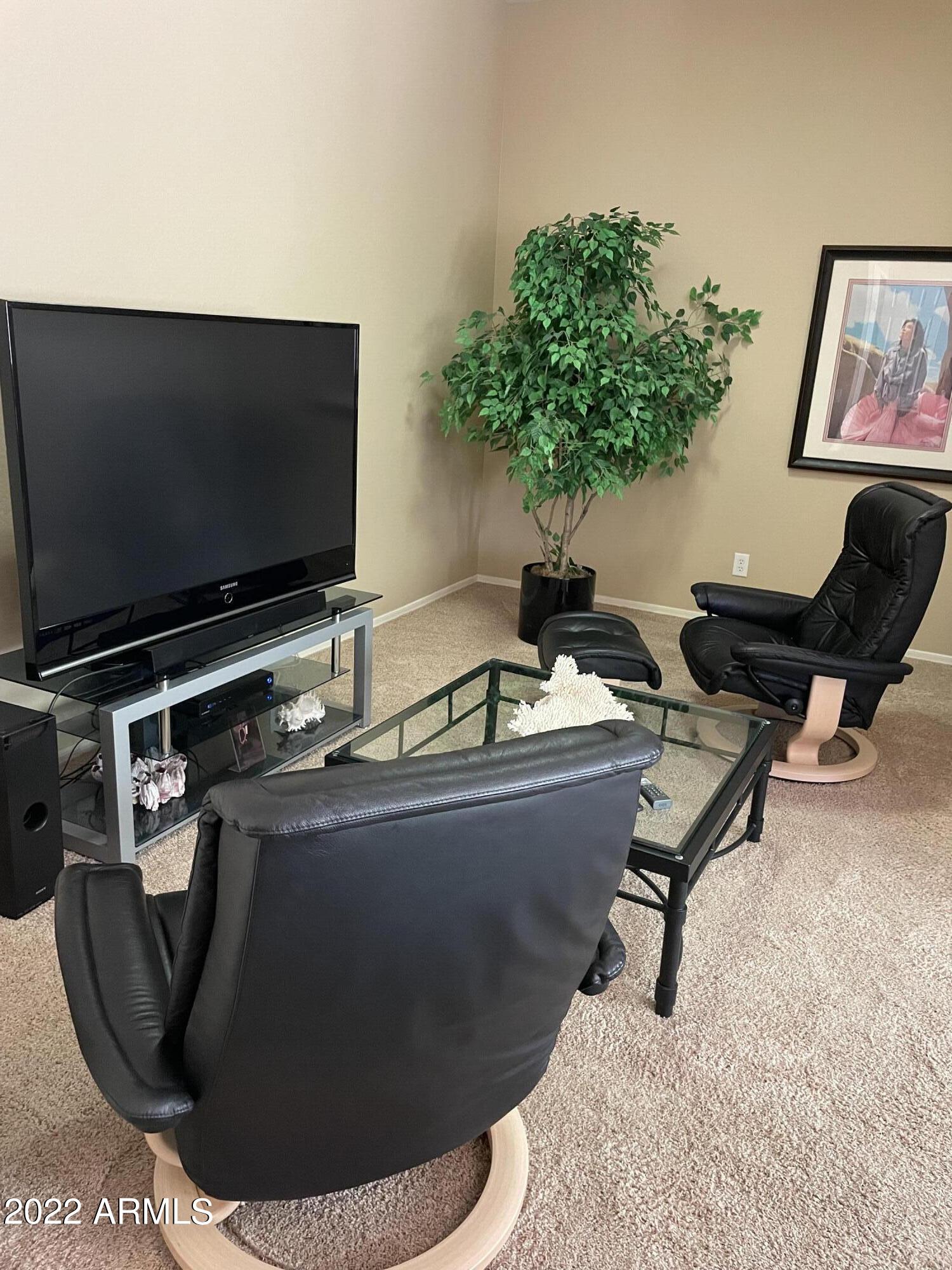 4604 West Moss Springs Road Phoenix, AZ 85086 - Photo 15 of 15 a living room with furniture and a flat screen tv