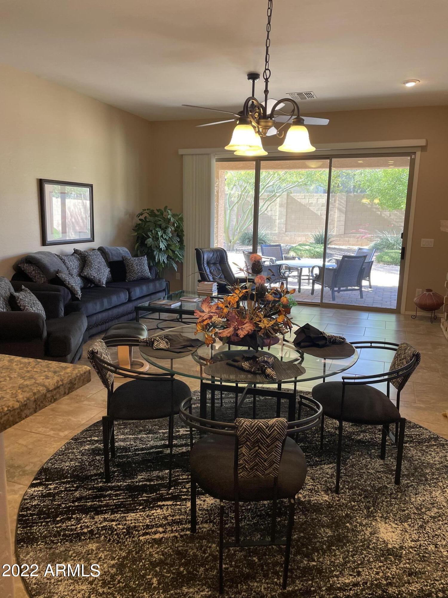 4604 West Moss Springs Road Phoenix, AZ 85086 - Photo 6 of 15 a view of a dining room with furniture window and outside view