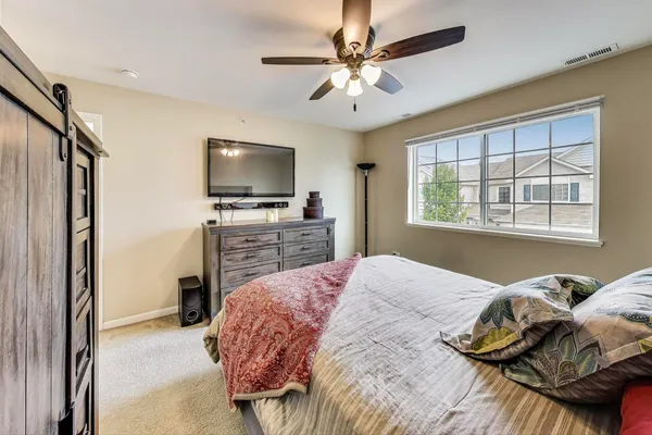 a bedroom with a bed and a television