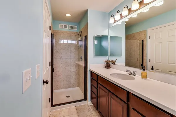a bathroom with a shower sink and mirror