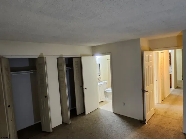 a view of a livingroom with kitchen space and window
