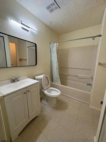 a bathroom with a toilet sink and shower