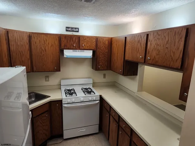 a kitchen with a sink and a stove top oven