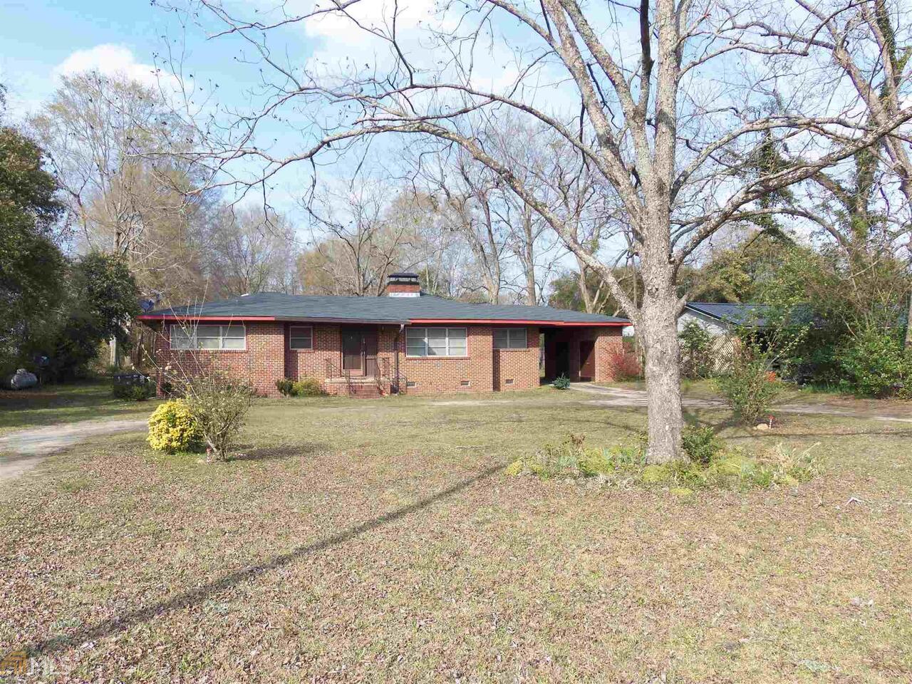 4 Columbus Road Butler, GA 31006 - Photo 1 of 1 a view of a house with a yard and large tree