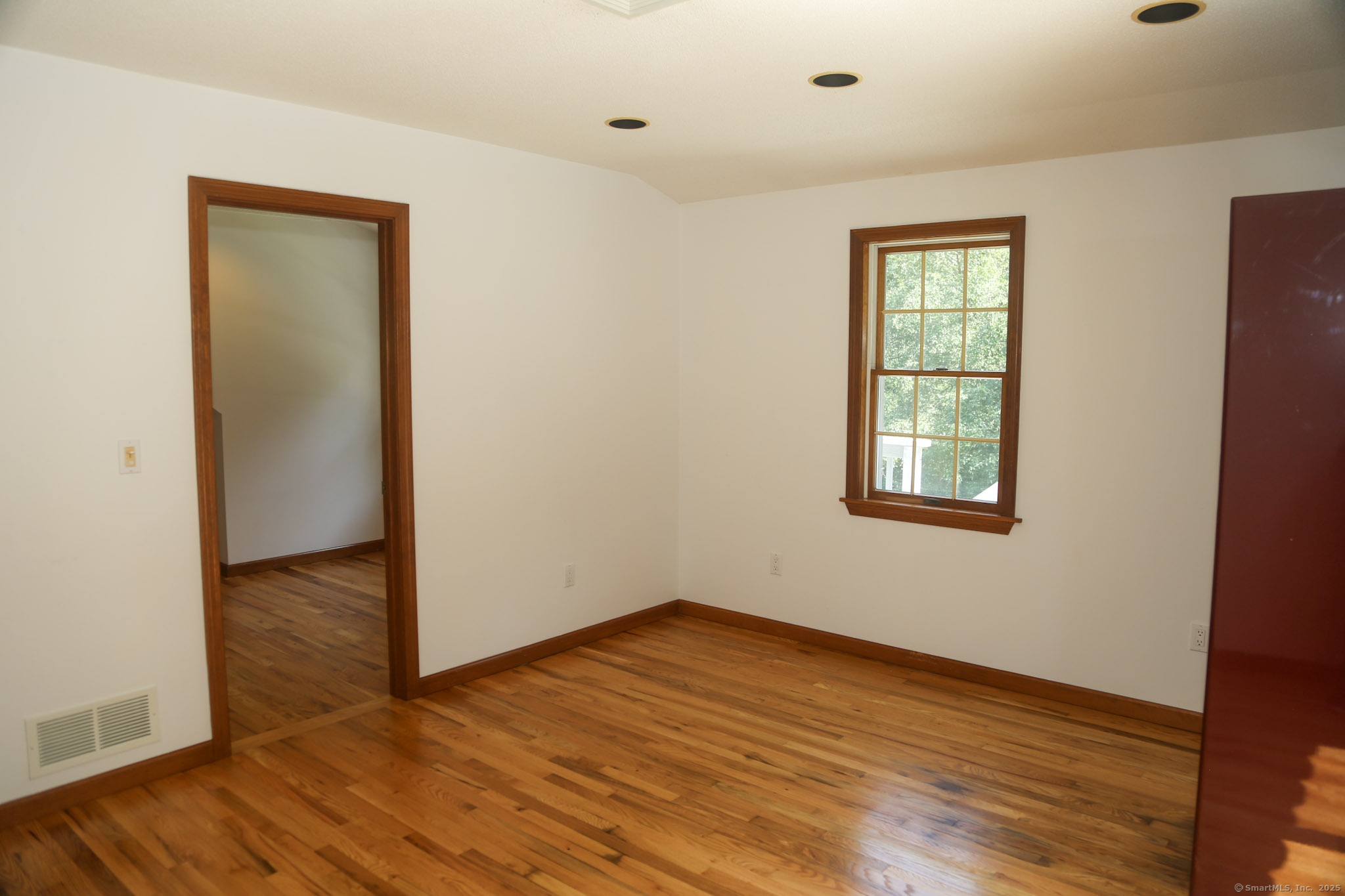 189 Crane Hollow Road Bethlehem, CT 06751 - Photo 15 of 40 an empty room with wooden floor and windows