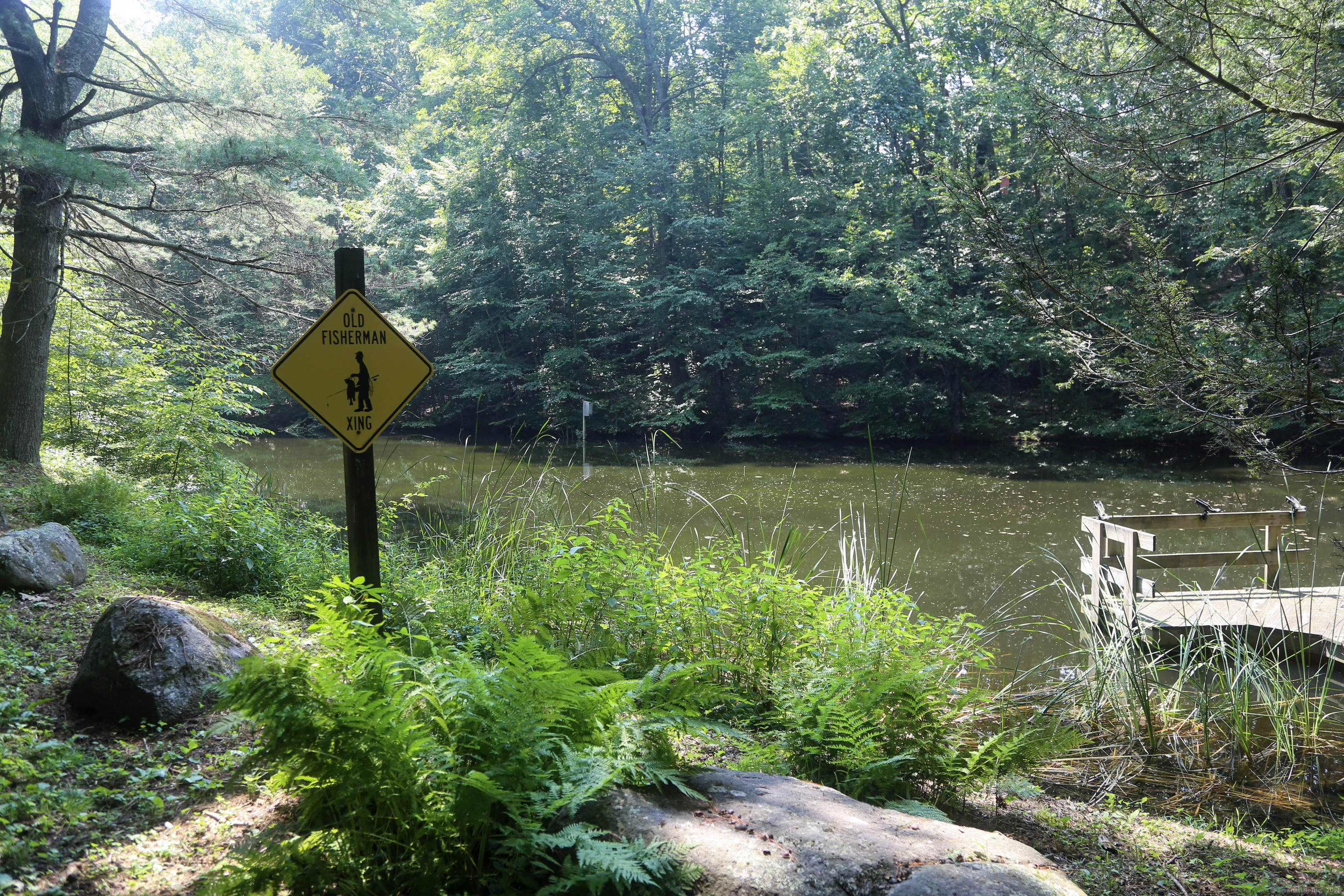189 Crane Hollow Road Bethlehem, CT 06751 - Photo 30 of 40 a view of a lake with a house in the background
