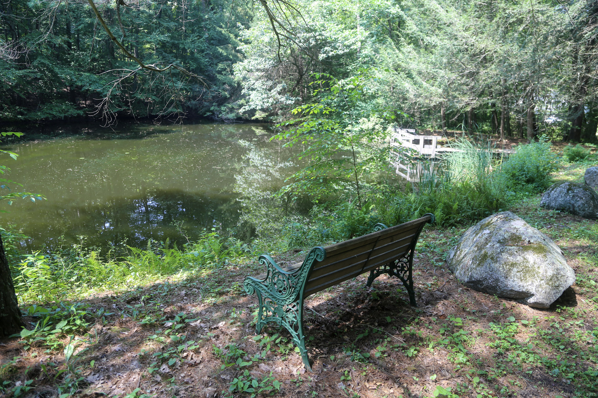 189 Crane Hollow Road Bethlehem, CT 06751 - Photo 33 of 40 a wooden bench sitting in the middle of a forest