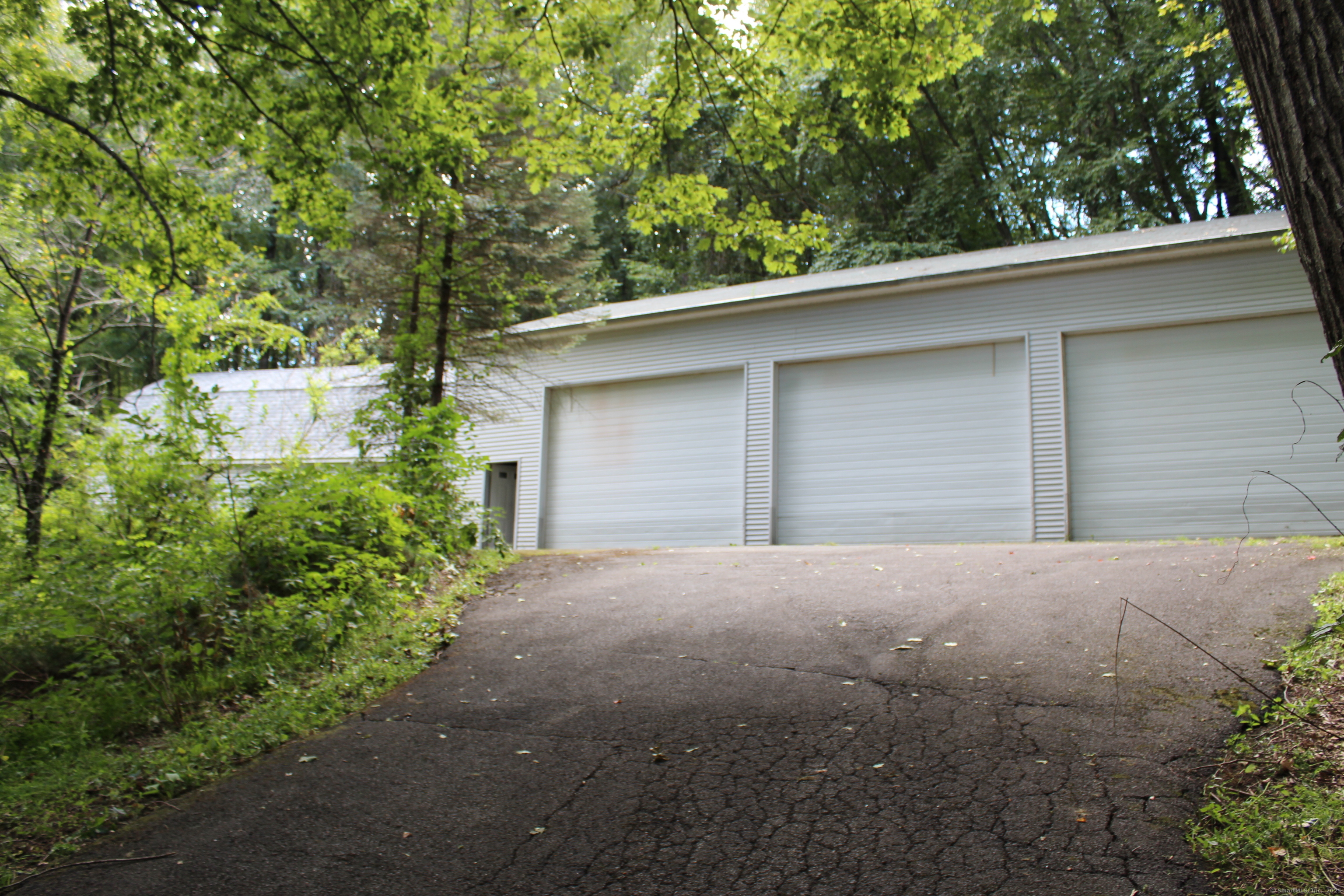189 Crane Hollow Road Bethlehem, CT 06751 - Photo 40 of 40 a brick house with trees in front of it