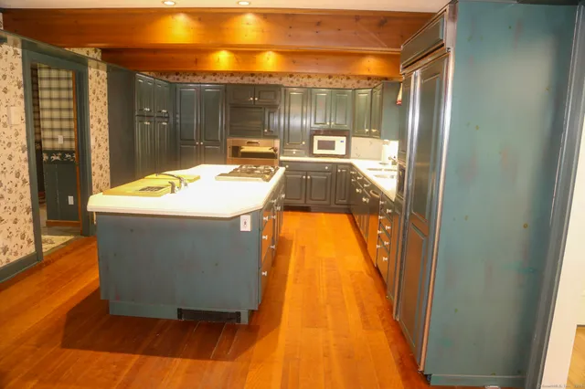 a kitchen with a sink and a stove top oven