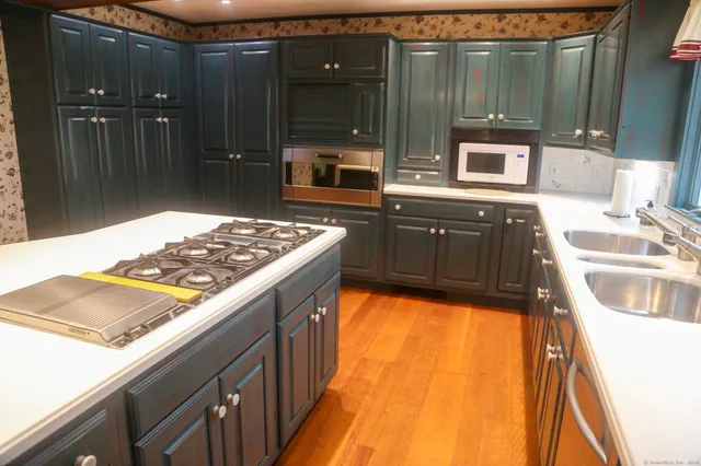 a view of an empty room with a fireplace and a window
