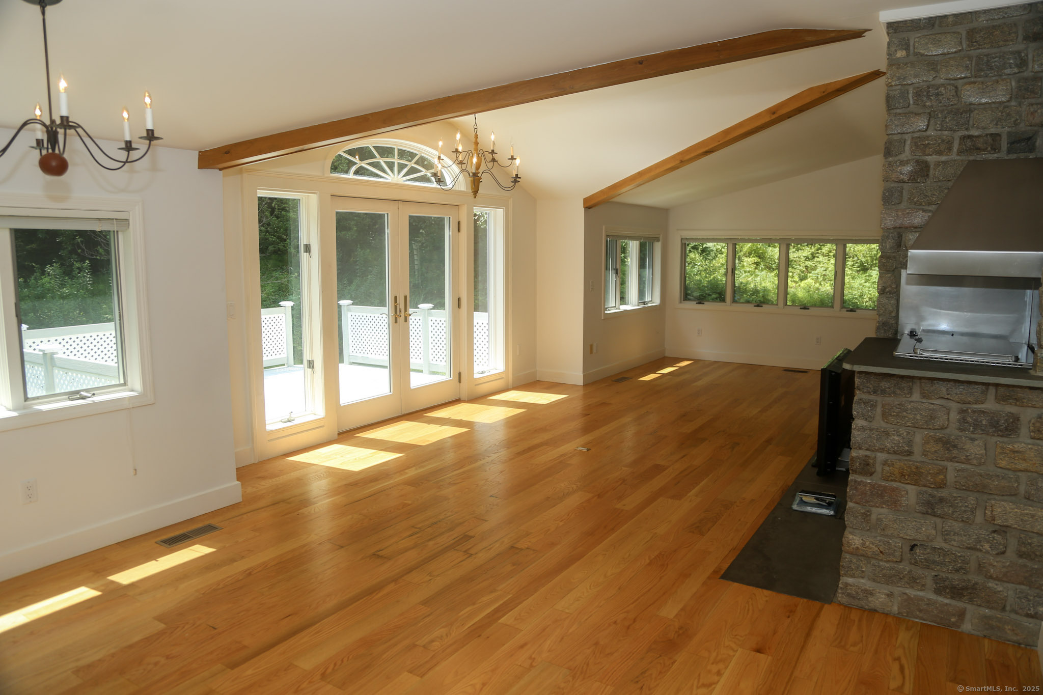 189 Crane Hollow Road Bethlehem, CT 06751 - Photo 7 of 40 a view of an empty room with a fireplace and a window