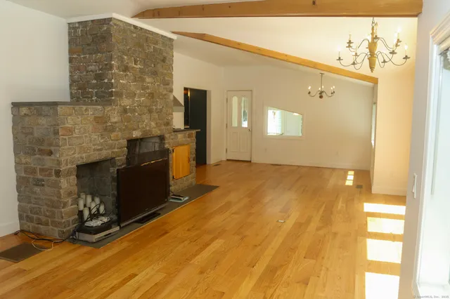 a living room with fireplace furniture and a wooden floor
