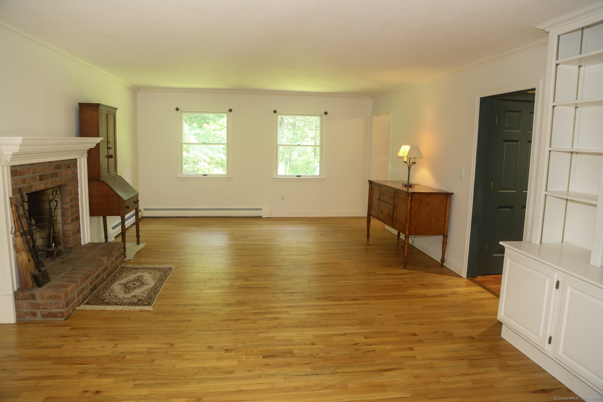 189 Crane Hollow Road Bethlehem, CT 06751 - Photo 9 of 40 a living room with fireplace furniture and a wooden floor
