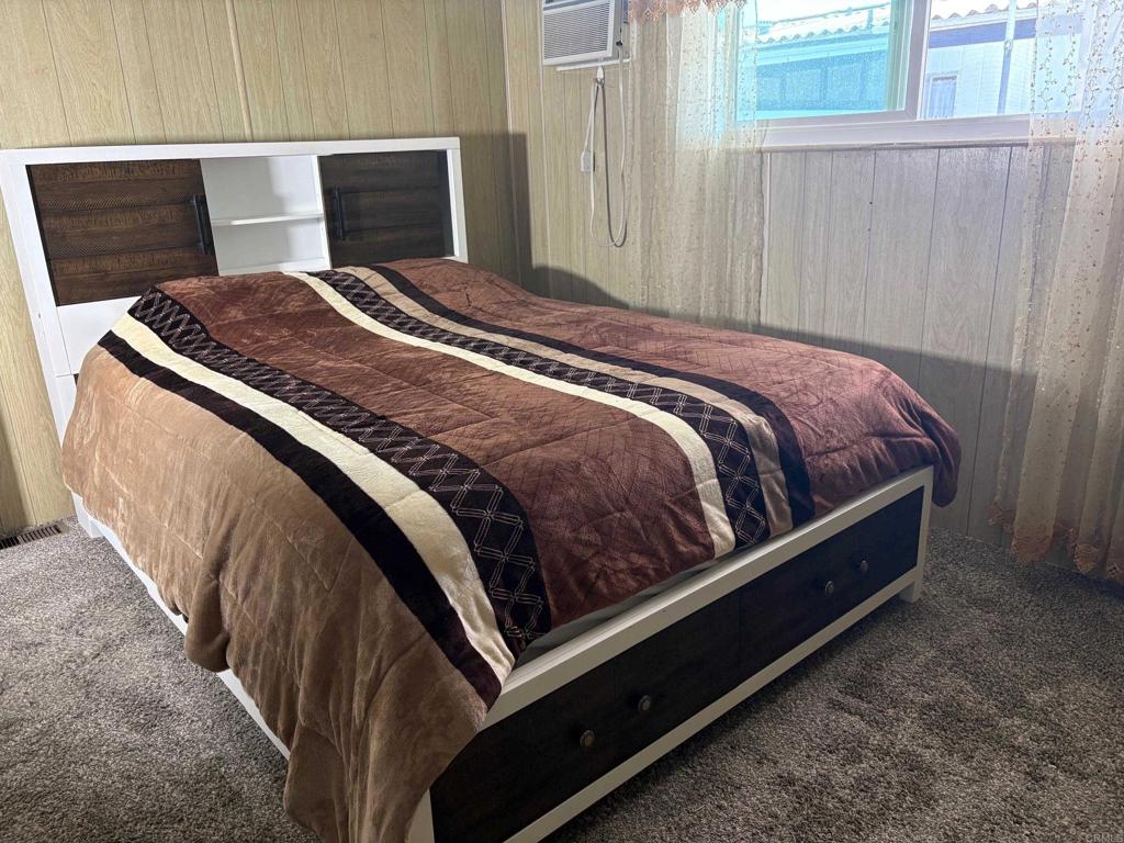 1174 East Main Street, Unit 113 El Cajon, CA 92021 - Photo 13 of 25 a bed sitting in a bedroom next to a window