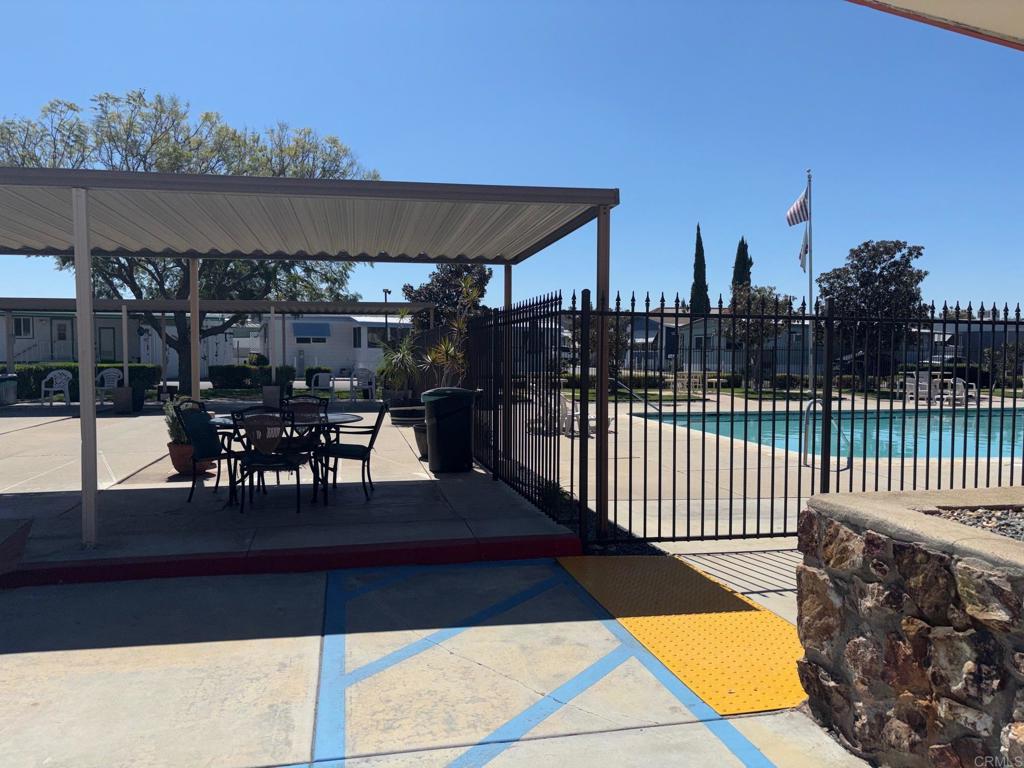 1174 East Main Street, Unit 113 El Cajon, CA 92021 - Photo 24 of 25 a view of a balcony with dining table and chairs