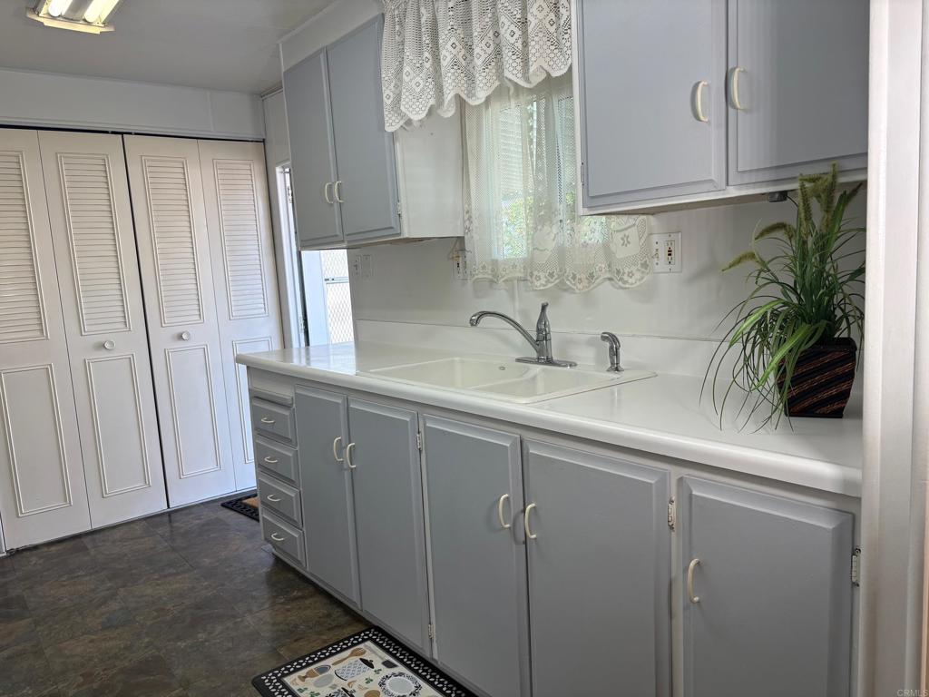 1174 East Main Street, Unit 113 El Cajon, CA 92021 - Photo 3 of 25 a kitchen with a sink and cabinets