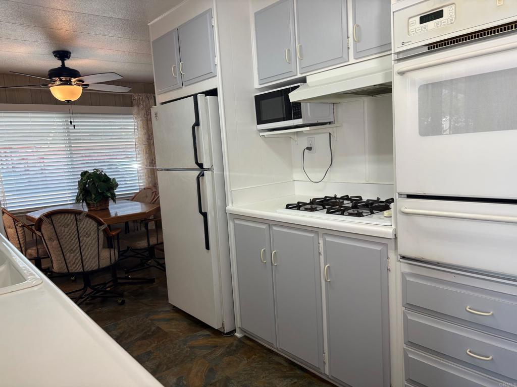 1174 East Main Street, Unit 113 El Cajon, CA 92021 - Photo 4 of 25 a kitchen with stainless steel appliances a refrigerator and a stove