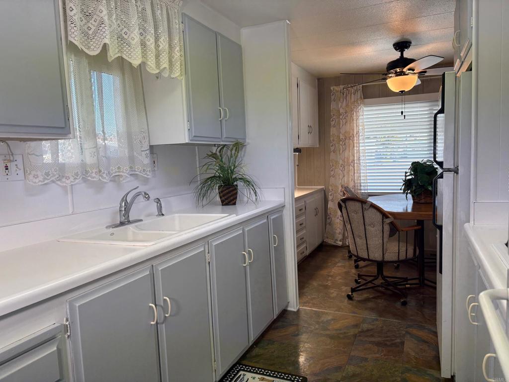 1174 East Main Street, Unit 113 El Cajon, CA 92021 - Photo 6 of 25 a kitchen with a sink cabinets and a window