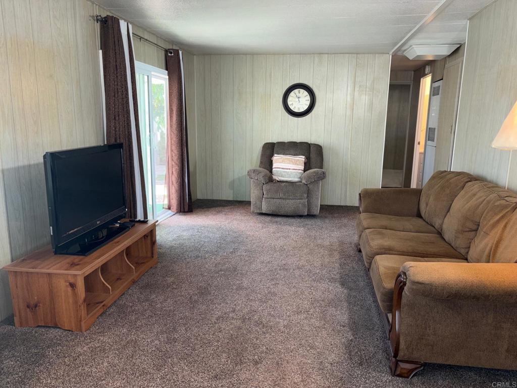 1174 East Main Street, Unit 113 El Cajon, CA 92021 - Photo 10 of 25 a living room with furniture and a flat screen tv
