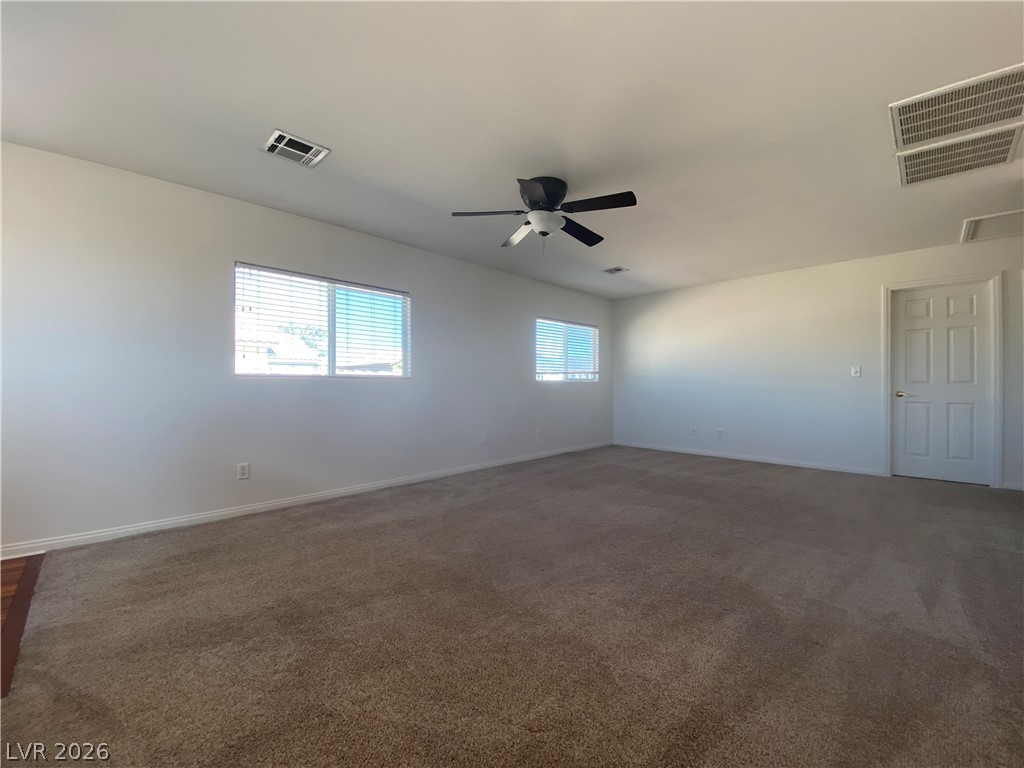 2023 Peacemaker Road Las Vegas, NV 89183 - Photo 8 of 24 Generous wall space and soft carpeting define this versatile interior living area.