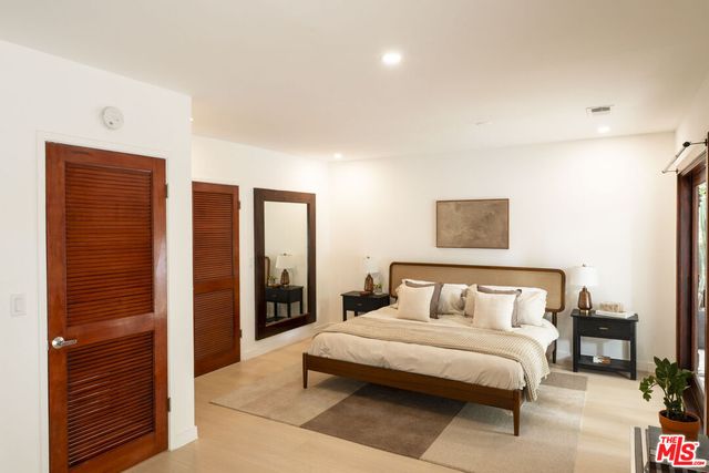 a bedroom with a bed and a night stand