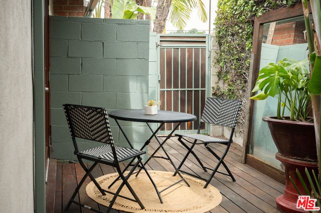 a view of a chairs and table in the balcony