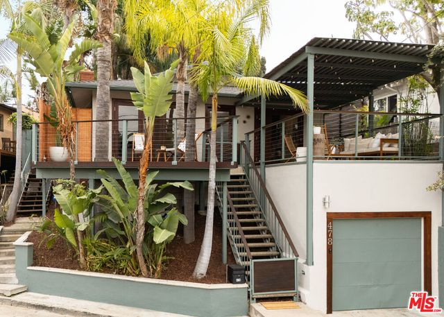 a view of living room with patio furniture and wooden floor