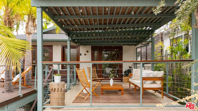 a view of a chairs and table in the balcony