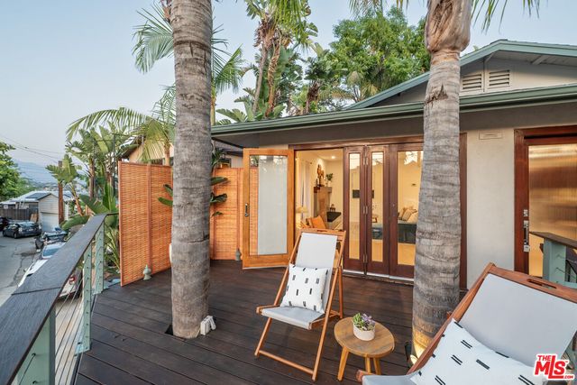 a view of a living room with furniture and wooden floor