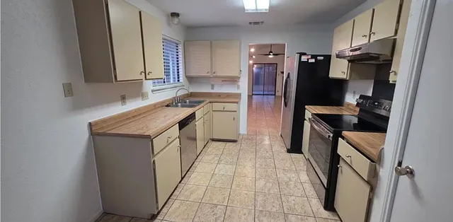a kitchen with a sink stove and refrigerator