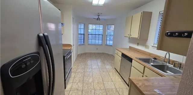 a view of a kitchen with a sink a washer and dryer