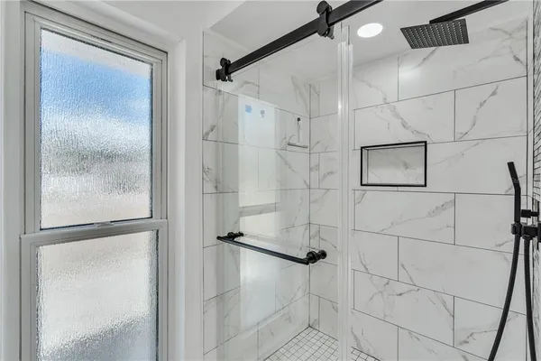 a bathroom with a glass shower door