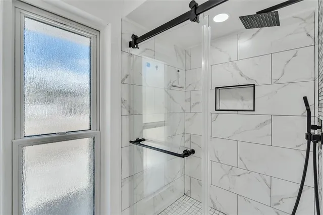 a bathroom with a glass shower door