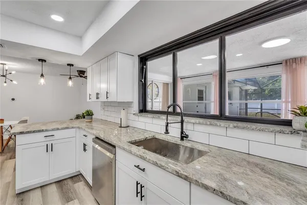 a kitchen with a sink cabinets and window