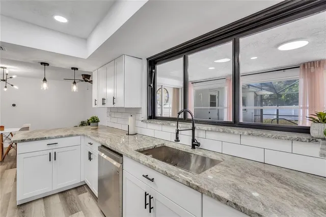 a kitchen with a sink cabinets and window
