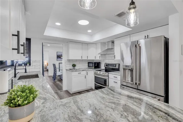 a kitchen with sink cabinets and stainless steel appliances