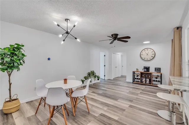 a dining room with furniture and a chandelier