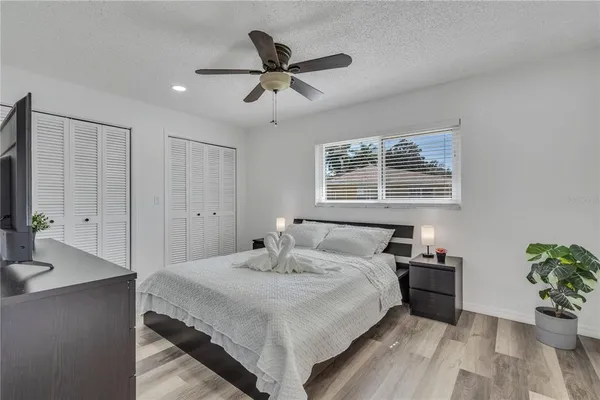 a bedroom with a bed and a potted plant