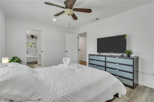 a bedroom with a bed and a flat screen tv