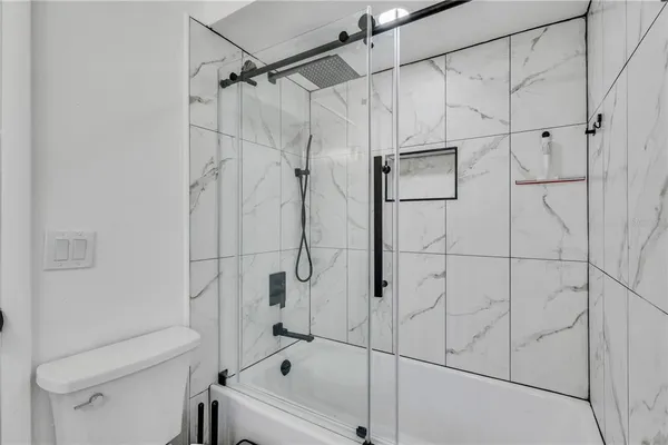 a bathroom with a bathtub and a shower